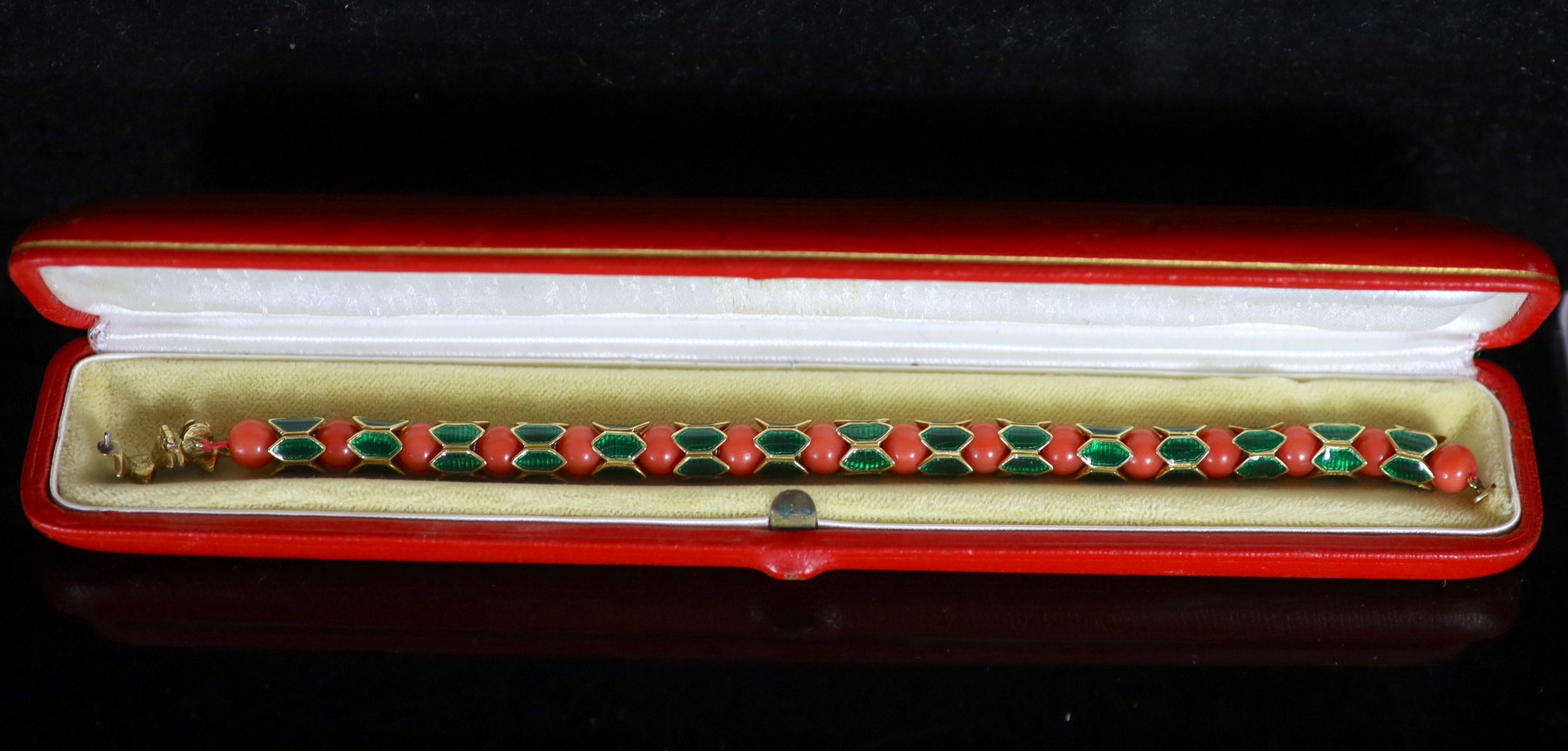 A good 1950's Cartier gold, coral bead and green enamel set articulated bracelet